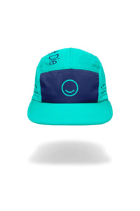 Turquoise and navy cap with a smiley face design on a white background
